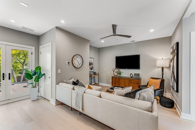 living room featuring ceiling fan, french doors, and light hardwood / wood-style flooring