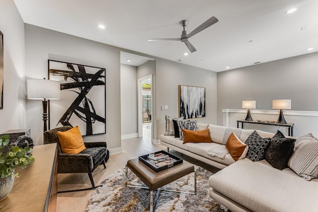 living room featuring ceiling fan and light hardwood / wood-style floors