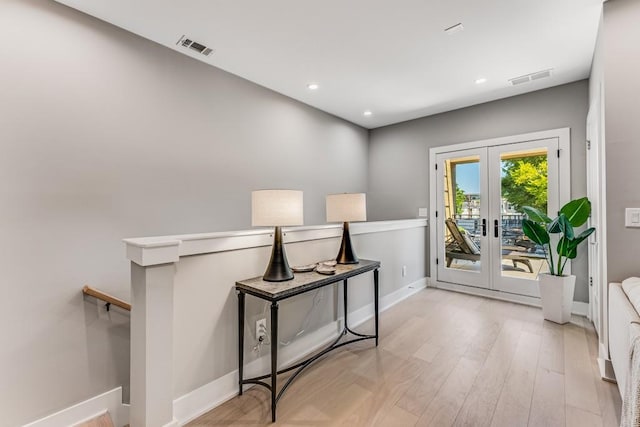 doorway to outside with french doors and light hardwood / wood-style floors