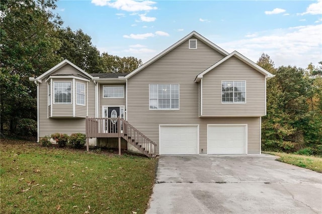 split foyer home featuring a garage and a front yard