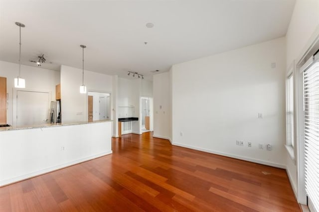 870 Inman Village Pkwy Unit 203, Atlanta, GA 30307 - unfurnished living room featuring wood finished floors and rail lighting