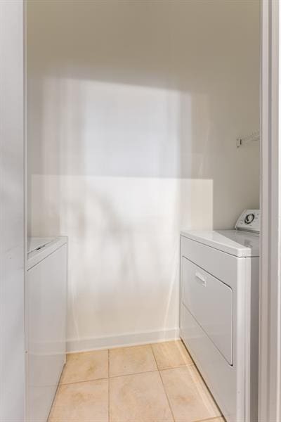 870 Inman Village Pkwy Unit 203, Atlanta, GA 30307 - washroom with washer and clothes dryer and light tile patterned floors