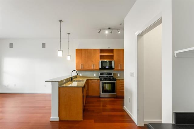 870 Inman Village Pkwy Unit 203, Atlanta, GA 30307 - kitchen featuring stainless steel range, brown cabinets, a peninsula, dark wood-style floors, and stone countertops