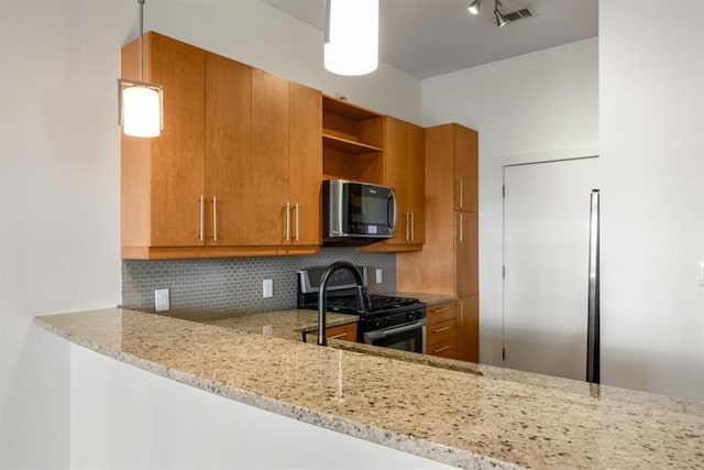 870 Inman Village Pkwy Unit 203, Atlanta, GA 30307 - kitchen with stainless steel range with gas cooktop, brown cabinets, open shelves, and light stone countertops