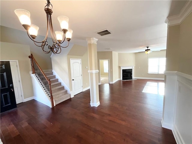 unfurnished living room with visible vents, a ceiling fan, stairway, ornate columns, and a fireplace