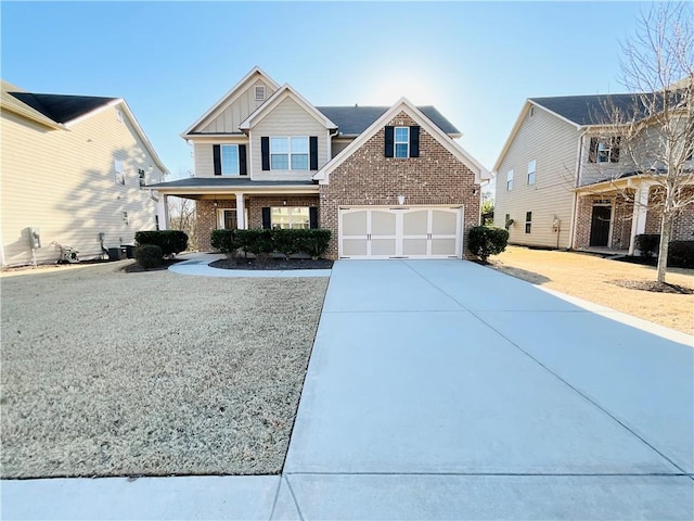 craftsman house featuring a garage, driveway, brick siding, and board and batten siding