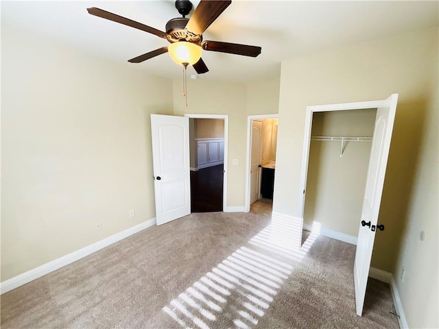 unfurnished bedroom with light carpet, ceiling fan, a closet, and baseboards