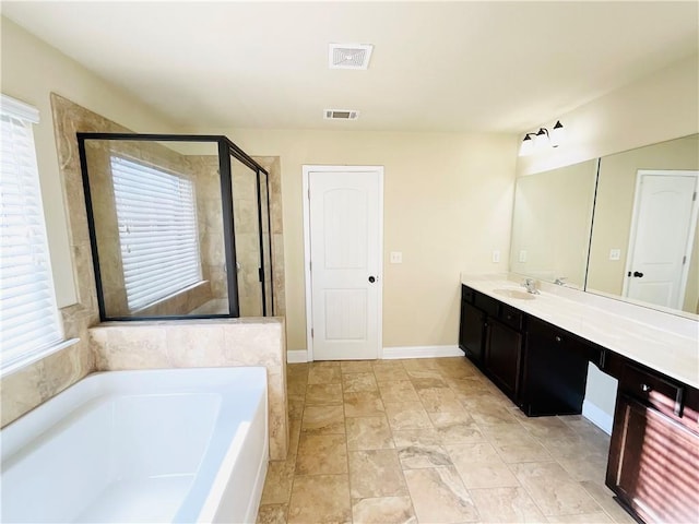 full bathroom with a garden tub, visible vents, a stall shower, vanity, and baseboards