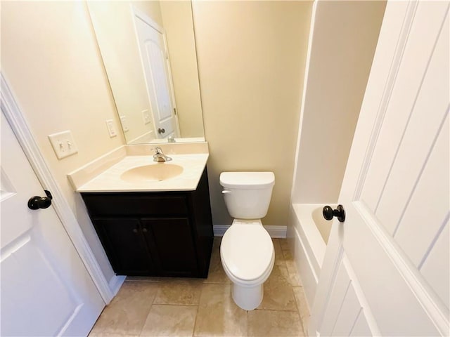 full bath with a tub to relax in, toilet, vanity, baseboards, and tile patterned floors