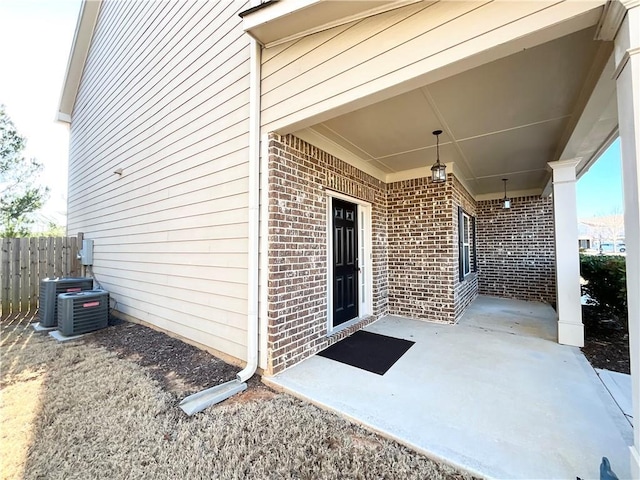 view of patio / terrace with fence and central AC unit