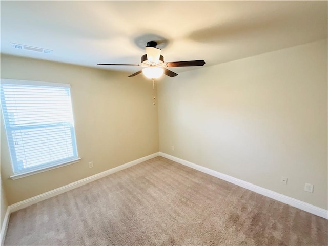 unfurnished room featuring baseboards, visible vents, and carpet flooring