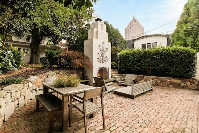 31 Lafayette Dr NE, Atlanta, GA 30309 - view of patio with an outdoor living space with a fireplace and outdoor dining area