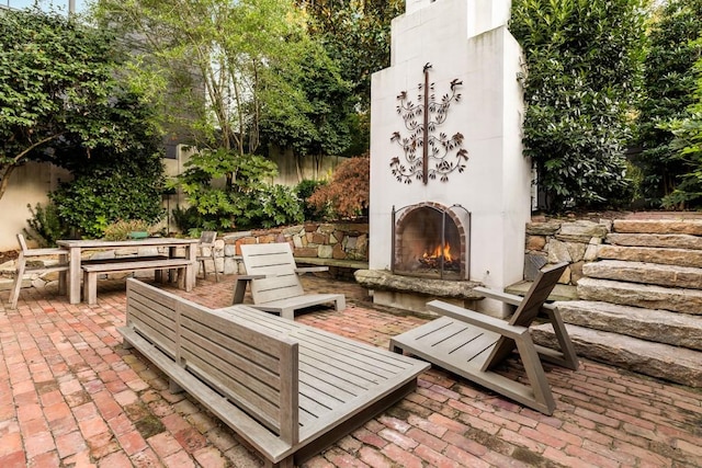 31 Lafayette Dr NE, Atlanta, GA 30309 - view of patio featuring a warm lit fireplace