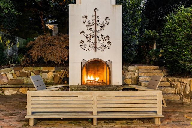 31 Lafayette Dr NE, Atlanta, GA 30309 - view of patio / terrace featuring a warm lit fireplace