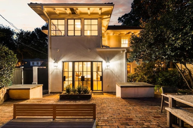 31 Lafayette Dr NE, Atlanta, GA 30309 - back of house at dusk with a patio and stucco siding