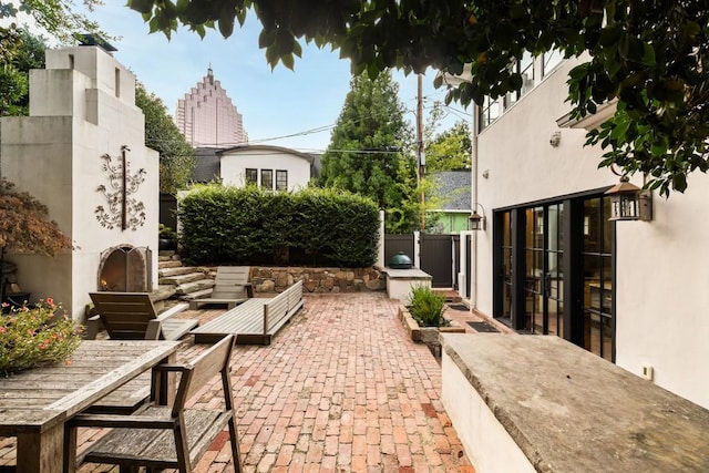 31 Lafayette Dr NE, Atlanta, GA 30309 - view of patio with a warm lit fireplace and outdoor dining area