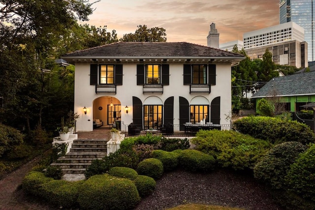 31 Lafayette Dr NE, Atlanta, GA 30309 - view of front facade with a chimney, stucco siding, and stairway