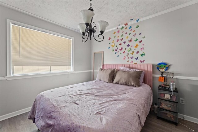 bedroom with a textured ceiling and dark hardwood / wood-style flooring