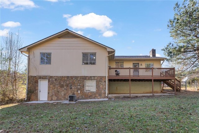 rear view of property with a yard, central AC unit, and a deck