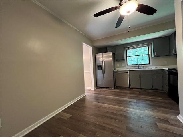 2065 Sandgate Cir, Atlanta, GA 30349 - kitchen featuring appliances with stainless steel finishes, ornamental molding, gray cabinets, light countertops, and dark wood-type flooring