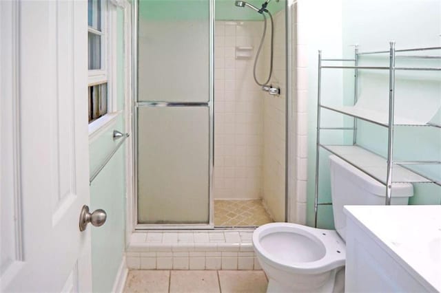 115 Elizabeth Way, Ellenwood, GA 30294 - bathroom featuring a shower stall, vanity, and tile patterned flooring