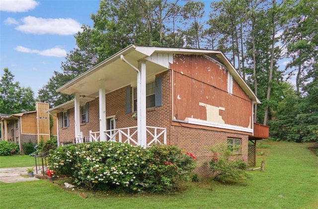 115 Elizabeth Way, Ellenwood, GA 30294 - view of property exterior with brick siding and a lawn