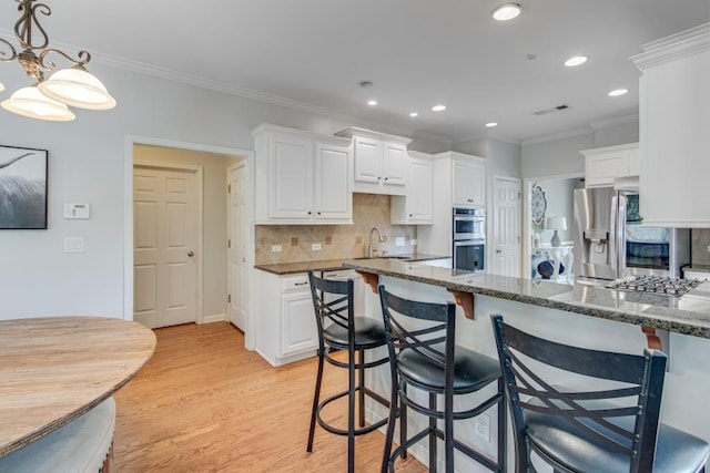 kitchen featuring white cabinets and dark stone counters