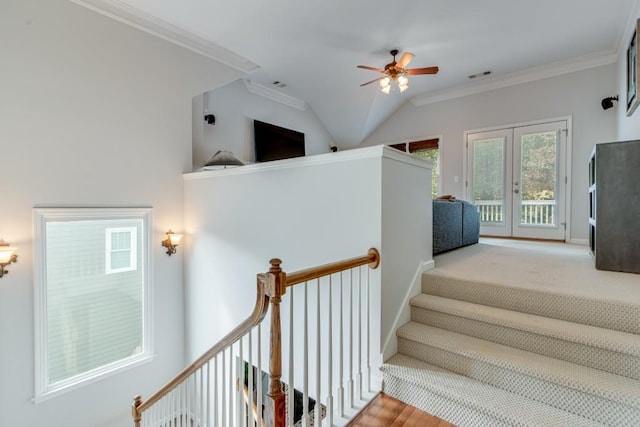 stairs featuring lofted ceiling, ornamental molding, and ceiling fan