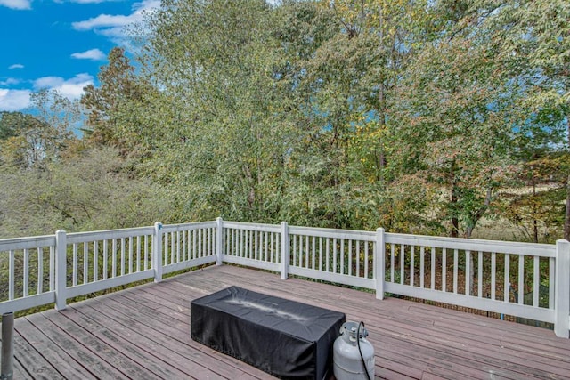 wooden deck featuring a grill