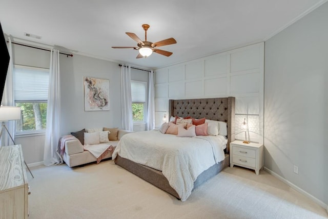 carpeted bedroom featuring crown molding and ceiling fan