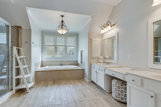 bathroom with crown molding, vanity, and independent shower and bath