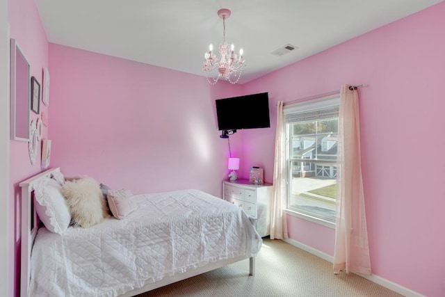 bedroom featuring light colored carpet and a chandelier