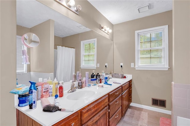 1574 Glenfield Dr, Lawrenceville, GA 30043 - full bath with double vanity, tile patterned floors, baseboards, and a shower with shower curtain