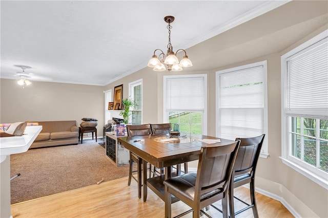 1574 Glenfield Dr, Lawrenceville, GA 30043 - dining area featuring light wood-type flooring, crown molding, a chandelier, and baseboards