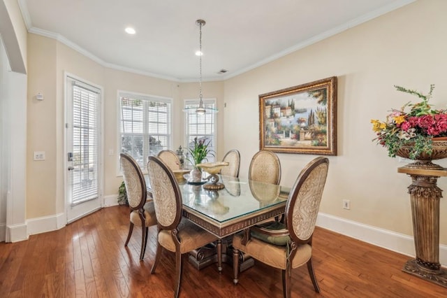 dining space with baseboards, ornamental molding, and hardwood / wood-style floors