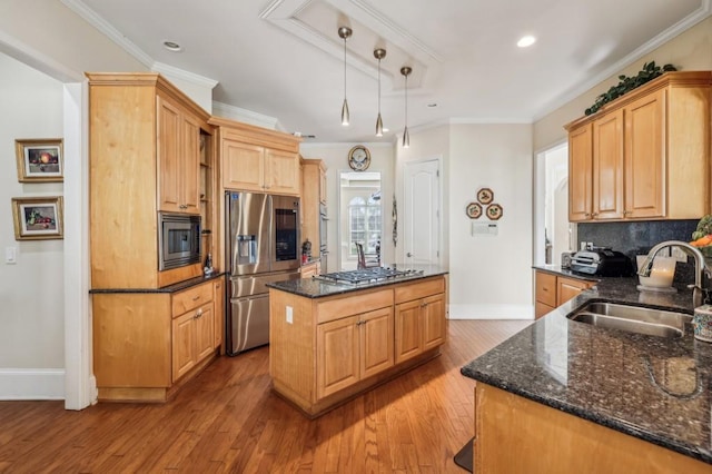 kitchen with stainless steel appliances, ornamental molding, a kitchen island, and a sink