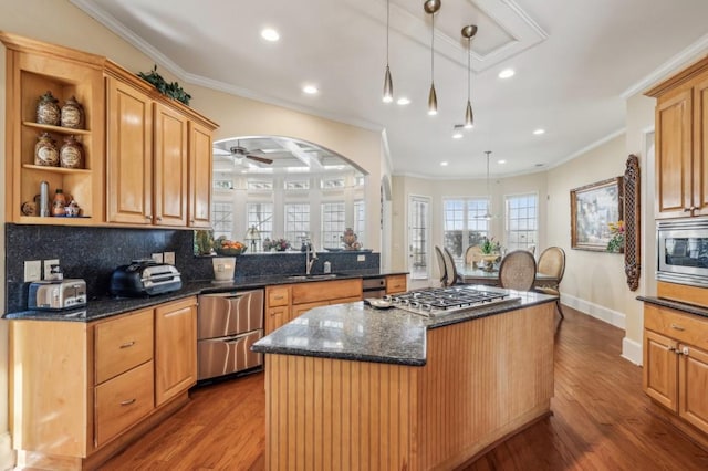 kitchen with a kitchen island, appliances with stainless steel finishes, crown molding, open shelves, and a sink