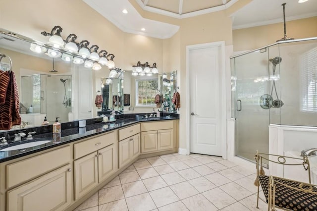 bathroom featuring double vanity, ornamental molding, a stall shower, a sink, and tile patterned floors