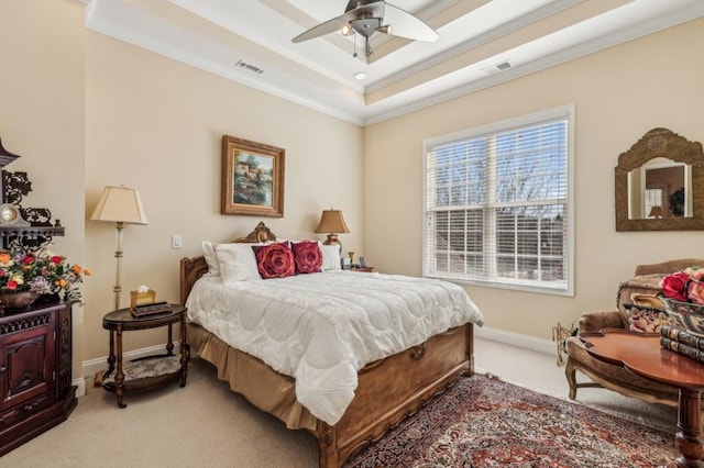 bedroom featuring light carpet, a tray ceiling, visible vents, and crown molding