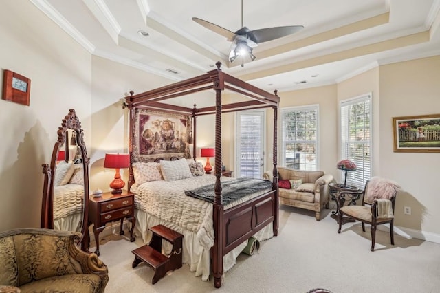 bedroom with baseboards, ornamental molding, a raised ceiling, and light colored carpet