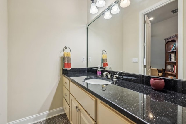 bathroom with visible vents, vanity, and baseboards