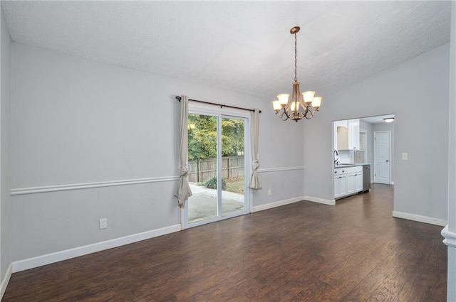 empty room featuring dark wood-type flooring, a textured ceiling, lofted ceiling, and an inviting chandelier