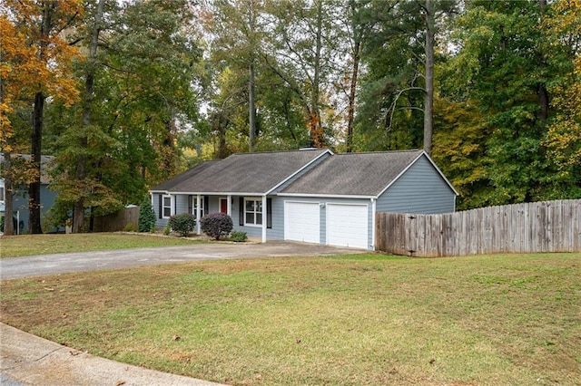 view of front of home with a front yard and a garage