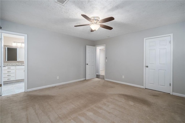 unfurnished bedroom with light carpet, a textured ceiling, and ceiling fan