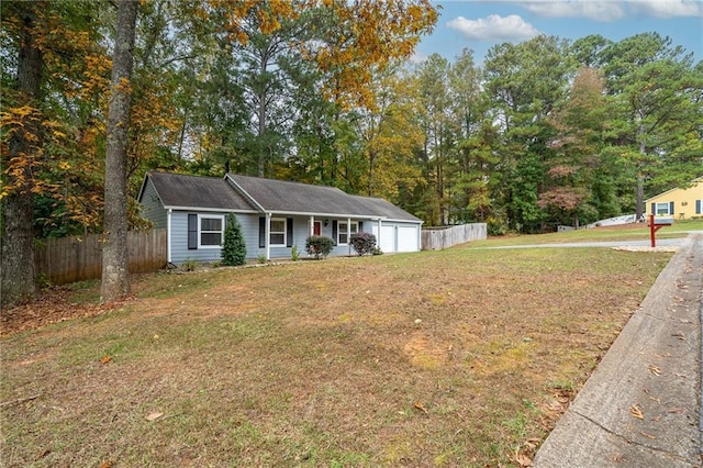 view of front of home featuring a front lawn and a garage