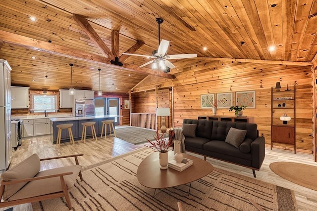 living room with light wood-style floors, wooden ceiling, vaulted ceiling, and wooden walls