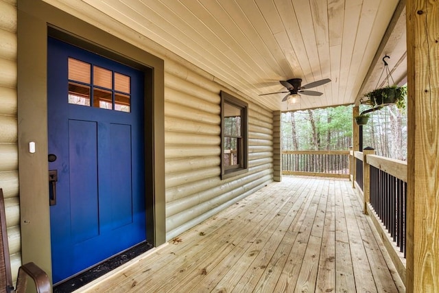 deck with ceiling fan and covered porch