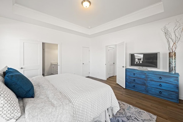 bedroom with ornamental molding, a raised ceiling, baseboards, and wood finished floors