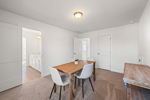 dining room with light colored carpet