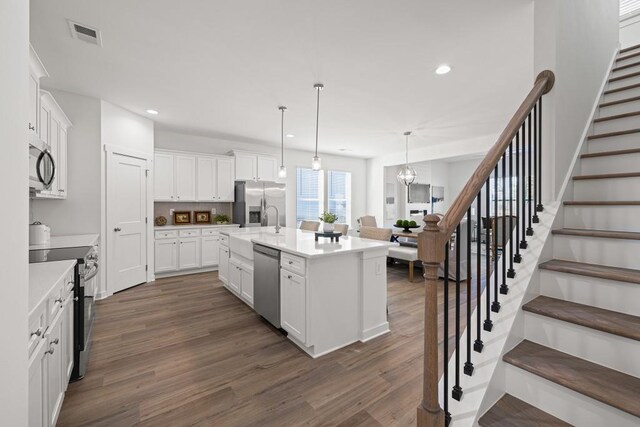 kitchen with white cabinetry, dark wood-type flooring, recessed lighting, and stainless steel appliances